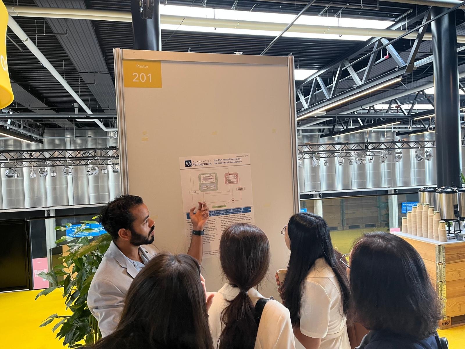 Discussing research at an Academy of Management 2025 poster session